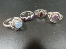 A COLLECTION OF FOUR 925 SILVER GEMSTONE DRESS RINGS TO INC AMETHYST, GARNET, MOONSTONE ETC