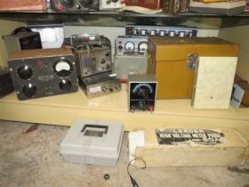 A LOWER SHELF CONTAINING VARIOUS INDUSTRIAL AND COMMERCIAL TESTING EQUIPMENT