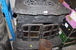 A CAST IRON LOG BURNER - TWO WAY LOAD PARTS, BEND AND CHIMNEY BY SMITH AND WELLSTOOD