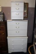 THREE WHITE BEDROOM CHESTS, A TV UNIT PLUS A WICKER TABLE