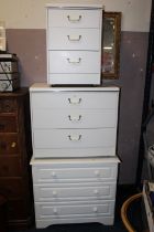 THREE WHITE BEDROOM CHESTS, A TV UNIT PLUS A WICKER TABLE