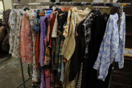 A COLLECTION OF ASSORTED VINTAGE CLOTHING COMPRISING SHIRTS, BLOUSES, DAY DRESSES ETC. TO INCLUDE