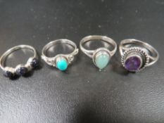 A COLLECTION OF FOUR 925 SILVER GEMSTONE DRESS RINGS TO INC AMETHYST, TURQUOISE AND MOONSTONE ETC