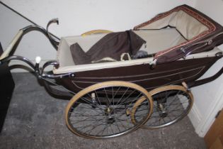 A VINTAGE FOUR WHEEL PRAM IN THE STYLE OF SILVERCROSS