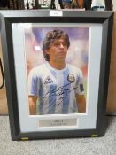 A FRAMED AND GLAZED SIGNED PICTURE OF DIEGO MARADONA