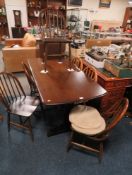 A DARK OAK ERCOL REFECTORY TABLE & SIX HOOPBACK CHAIRS - NOTE: TWO CHAIRS ARE LIGHT
