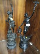 TWO SPELTER STYLE FIGURINES, ONE AT A SHIPS WHEEL THE OTHER OF A FEMALE ENGINEER