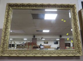 A LARGE MODERN GILT FRAMED MIRROR