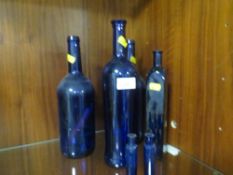 A SMALL COLLECTION OF BLUE GLASS BOTTLES