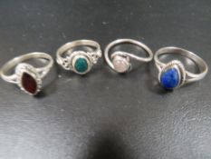 A COLLECTION OF FOUR 925 SILVER GEMSTONE DRESS RINGS TO INC GARNET, MOONSTONE ETC