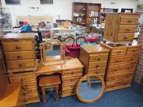 A HONEY PINE DRESSING TABLE, MIRROR, PAIR OF BEDSIDE CHEST, STOOL AND TWO LARGER CHESTS (7)