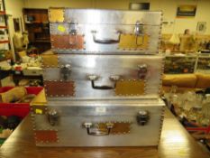 A MODERN GRADUATED SET OF THREE METAL SUITCASE STORAGE BOXES - LARGEST W 55 cm