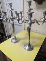 A PAIR OF POLISHED METAL CANDELABRA