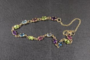 A 375 STAMPED GOLD BRACELET SET WITH MULTI-COLOURED STONES