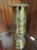 A REPRODUCTION MINORS LAMP IN GIFT TUBE