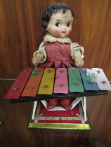 A TIN PLATE CLOCKWORK MODEL OF A GIRL PLAYING AN XAPHOON