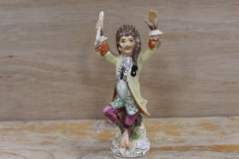 A CONTINENTAL PORCELAIN MONKEY BAND FIGURE