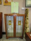 A VINTAGE OAK GLAZED BOOKCASE AND PAINTED CABINET (2)