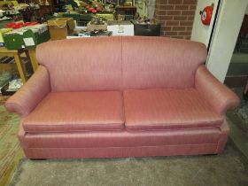 A LARGE PINK UPHOLSTERED SETTEE