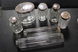 A SMALL TRAY OF SEVEN VARIOUS HALLMARKED SILVER TOPPED GLASS BOTTLES