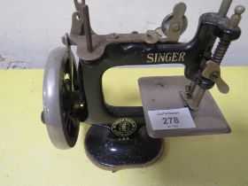 A SMALL MODEL SINGER USA SEWING MACHINE