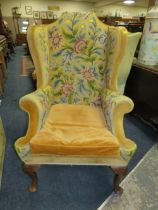 A LARGE COUNTRY HOUSE STYLE WING ARMCHAIR WITH NEEDLEPOINT UPHOLSTERY