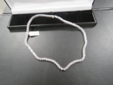 A SINGLE STRAND DIAMONIQUE SILVER AND CZ TENNIS STYLE NECKLACE