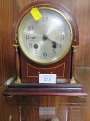 A SMALL ARCHED TOP MANTLE CLOCK