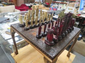 AN ORIENTAL CHESS SET WITH LARGE DETAILED FIGURES AND WOODEN CHESS TABLE WITH REVERSIBLE TOP TO