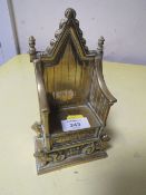 A BRASS MONEY BOX IN FORM OF A THRONE
