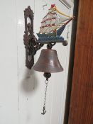 A MODERN CAST WALL MOUNTED METAL BELL IN THE FORM OF A SAIL SHIP