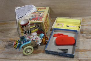 A VINTAGE BOXED CLOCKWORK TRICYCLE WITH BELL, TOGETHER WITH A VINTAGE BOXED JOHN BULL PRINTING