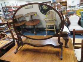 AN ANTIQUE OVAL DRESSING MIRROR AND LONG WALNUT STOOL