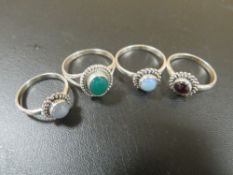A COLLECTION OF FOUR 925 SILVER GEMSTONE DRESS RINGS TO INC JADE, GARNET ETC