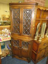 AN OAK GLAZED / LEADED CORNER CABINET