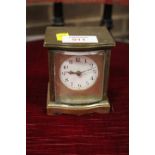 A SMALL BRASS TRAVEL CLOCK IN A BOW FRONTED CASE, A/F, H 9 cm