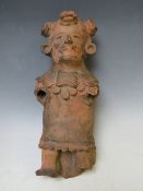 A SOUTH AMERICAN POTTERY FIGURE, hollow in form, lacking limbs, H 32 cm