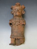 A SOUTH AMERICAN POTTERY FIGURE, hollow in form, lacking limbs, H 32 cm