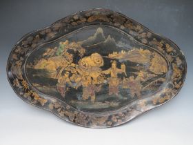 A LARGE SHAPED PAPIER MACHE TRAY, decorated with gilt painted Oriental figures in a landscape,, W 77