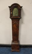 AN EARLY 20TH CENTURY SMALL WALNUT CASED GRAND DAUGHTER CLOCK, having arched brass dial bearing name