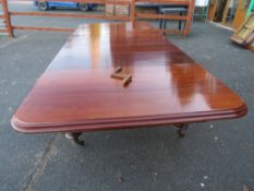 A MID VICTORIAN LARGE WIND-OUT DINING TABLE WITH FOUR LEAVES, raised on four heavy acanthus