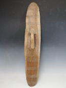 A VINTAGE AUSTRALIAN ABORIGINAL PARRYING SHIELD, W 15 cm, L 75 cm