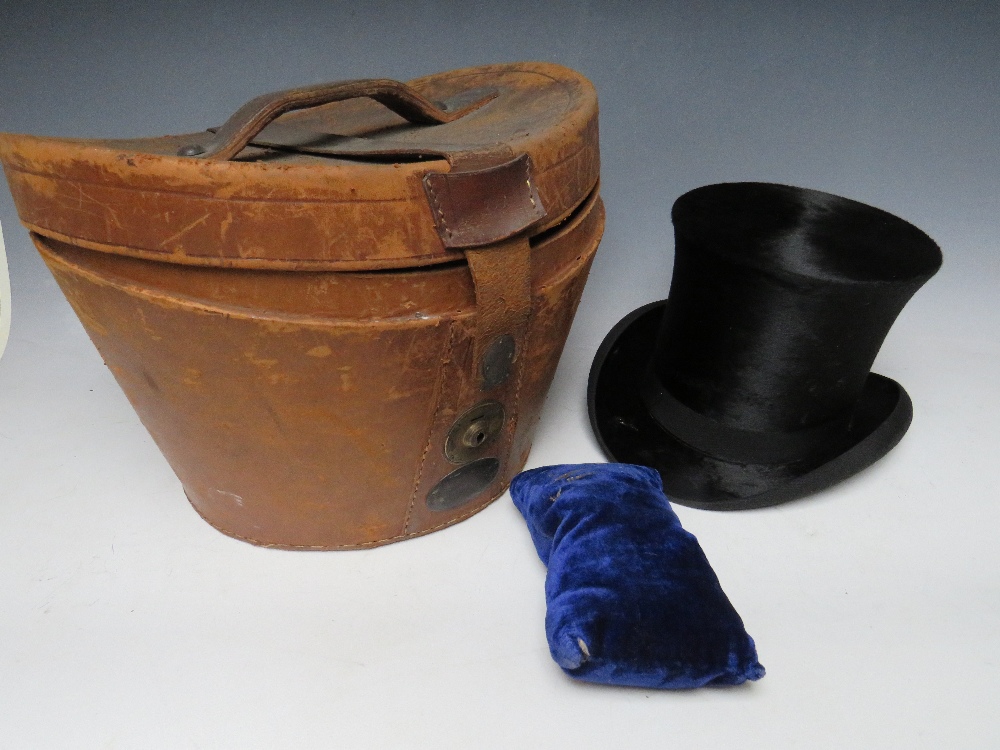 A VINTAGE LEATHER TOP HAT CASE WITH SILK TOP HAT, A/FCondition Report:Loss of silk to the brim of