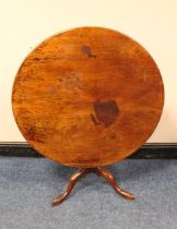 A GEORGIAN MAHOGANY TILT-TOP PEDESTAL TABLE, the one piece top raised on a tapered column and tripod