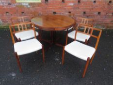 A DRYLUND FLIP FLAP LOTUS ROSEWOOD DINING TABLE AND SIX CHAIRS, the circular table having four