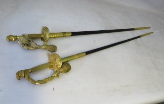 TWO EDWARDIAN COURT SWORDS, having gilded handles, grips and knight helmets pommels, the largest