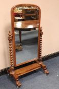 A MID VICTORIAN FULL-LENGTH CHEVAL MIRROR, held on barleytwist supports and scrolled feet, H 163 cm,
