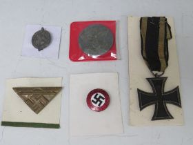 AN IRON CROSS, an NSDAP party membership badge a 1942 Kreigtag badge and two others