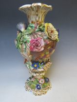 A LARGE PORCELAIN FLORAL ENCRUSTED VASE, decorated with cartouches of birds and fruit, gilt lined