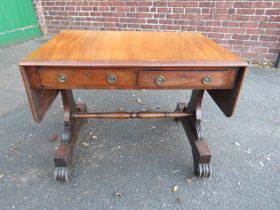 A 19TH CENTURY CROSSBANDED MAHOGANY SOFA TABLE, with two frieze drawers, raised on shaped supports